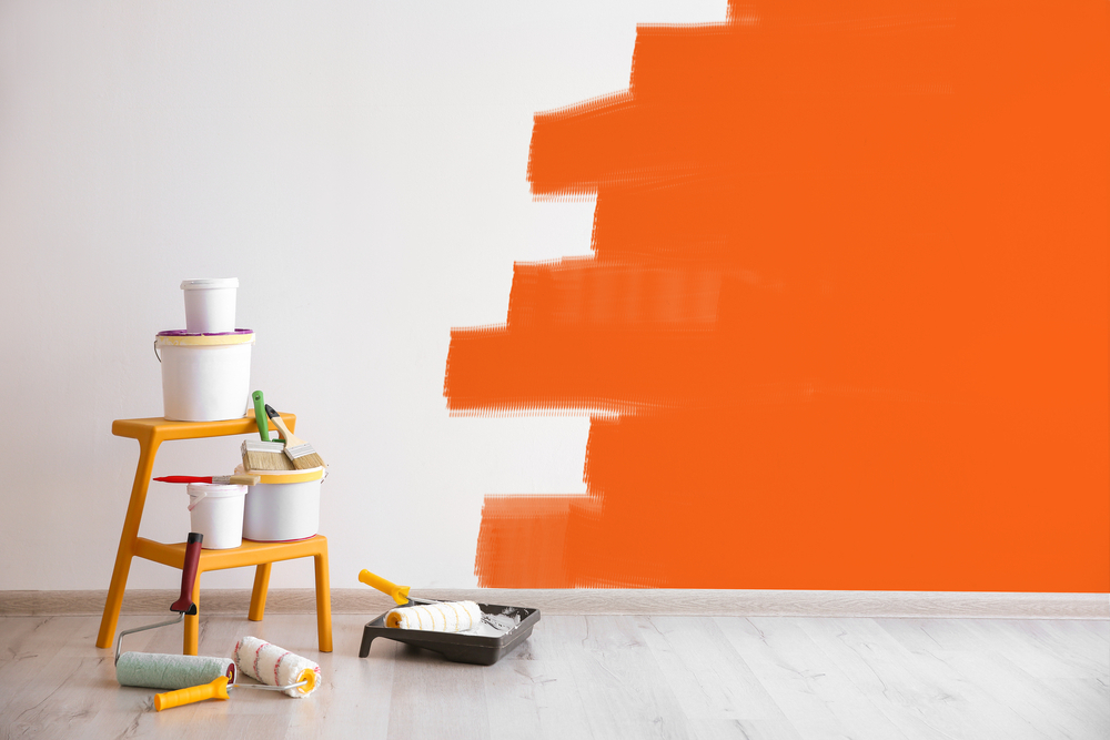 a Painting tools and a painted wall - The Impact of Color Psychology in Interior Painting