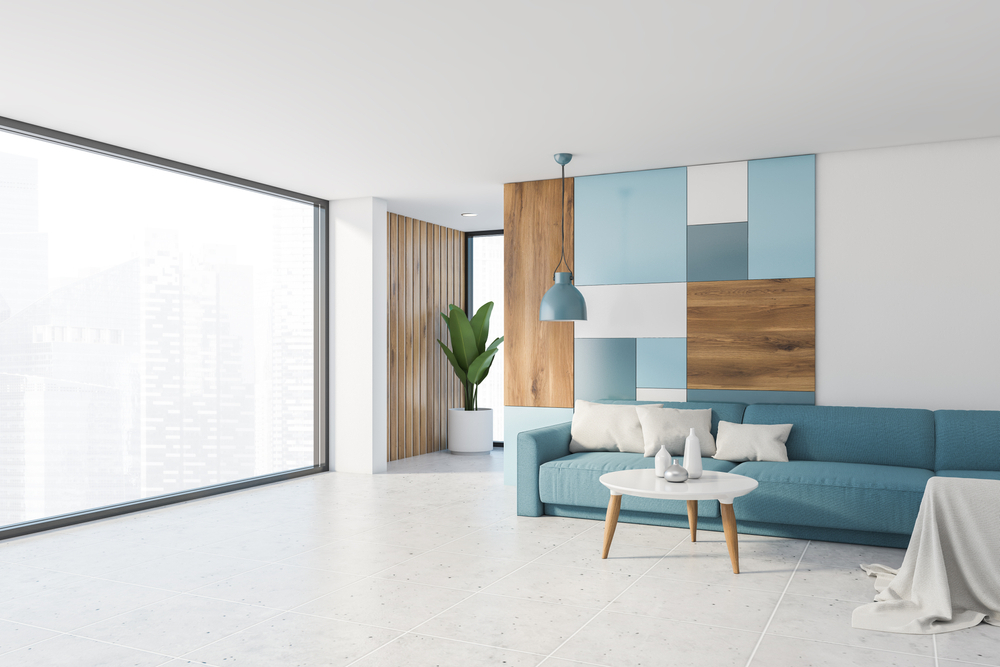 Bright panoramic corner of the living room with white wall and colorful pattern, tiled floor, comfortable blue sofa - The Secrets of Creating a Relaxing Ambience in Your Personal Space
