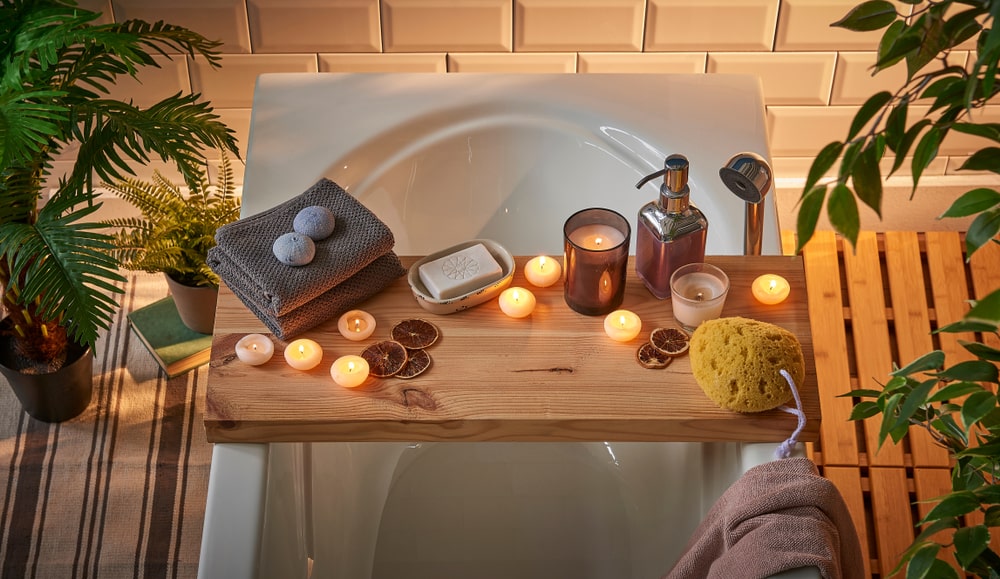 Spa bathtub wooden table vase of plant candle towel brush all kind of spa object - The Secrets of Creating a Relaxing Ambience in Your Personal Space