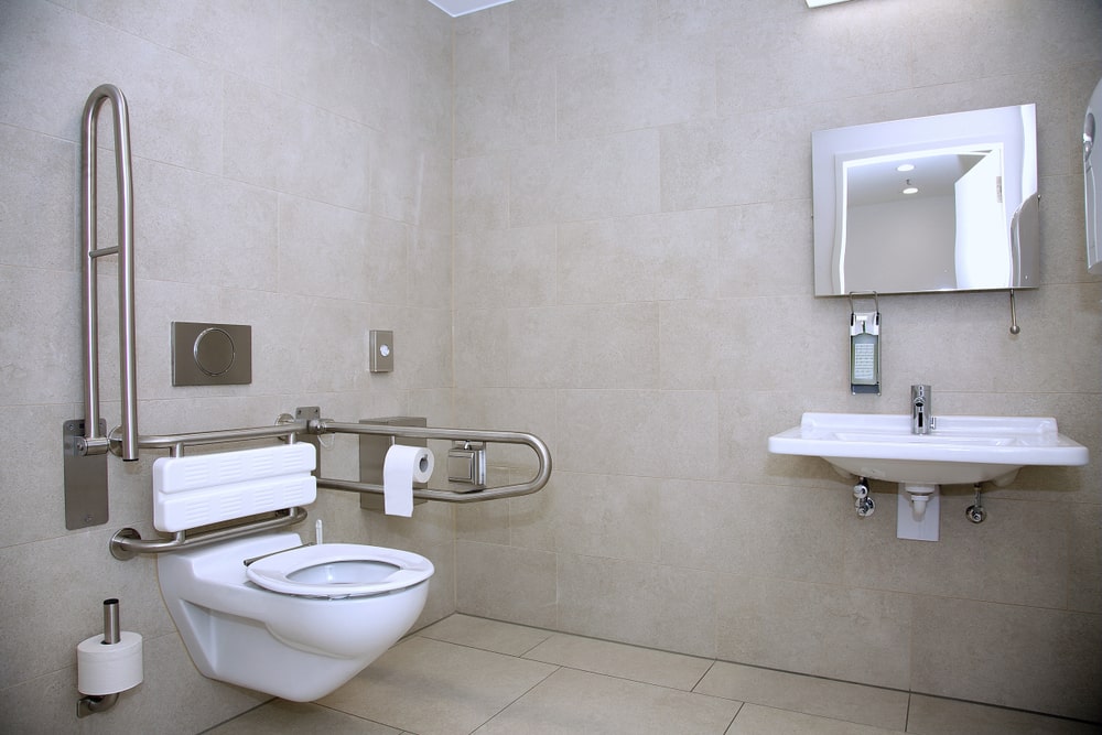 Modern handicapped bathroom for the elderly and disabled, with grab bars and wheelchair access